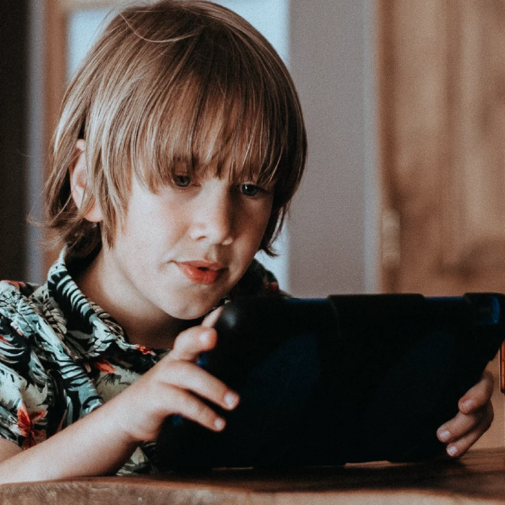 Photo: a young adult reads text on a tablet device.  (Photo: Annie Spratt, UNSPLASH)