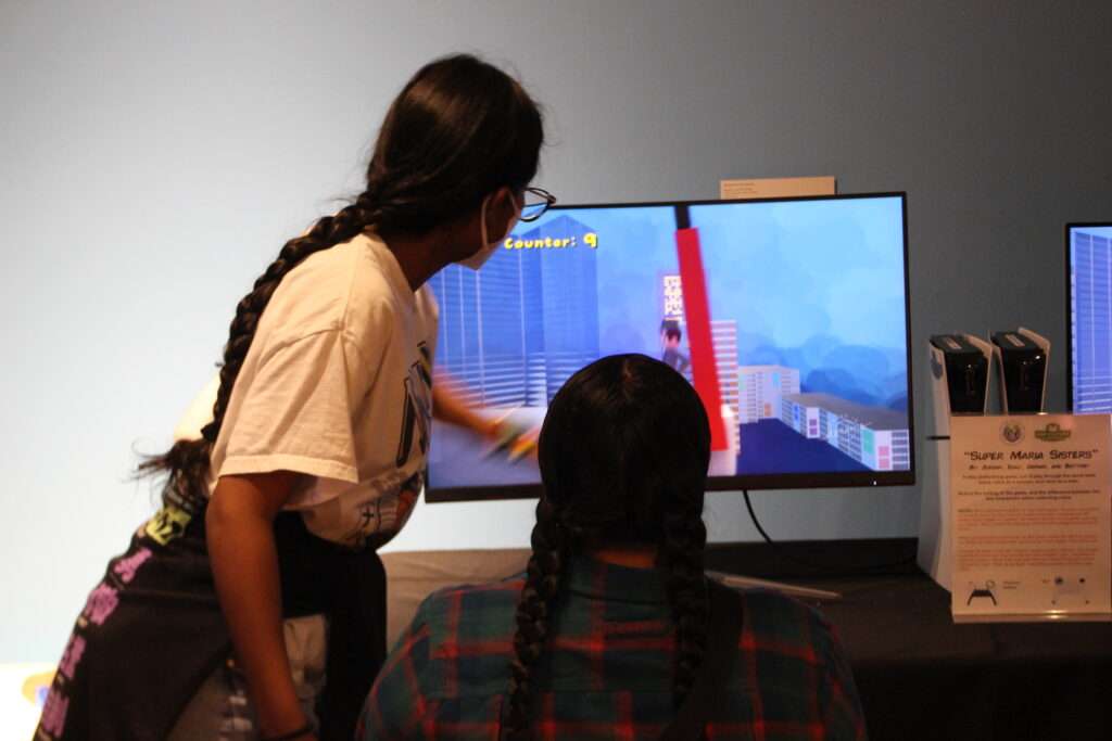 A student explains their game.